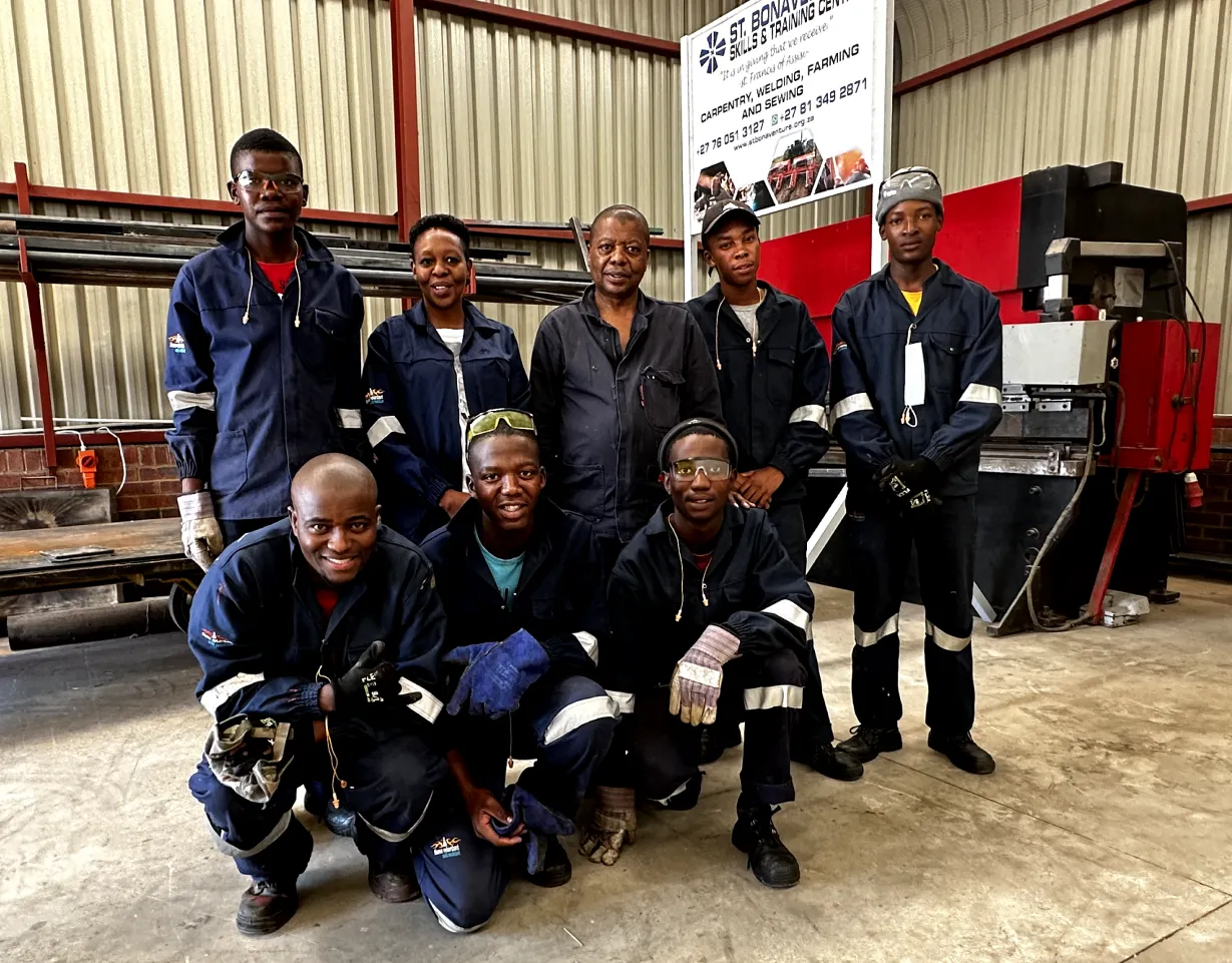 Photo of team in work overalls