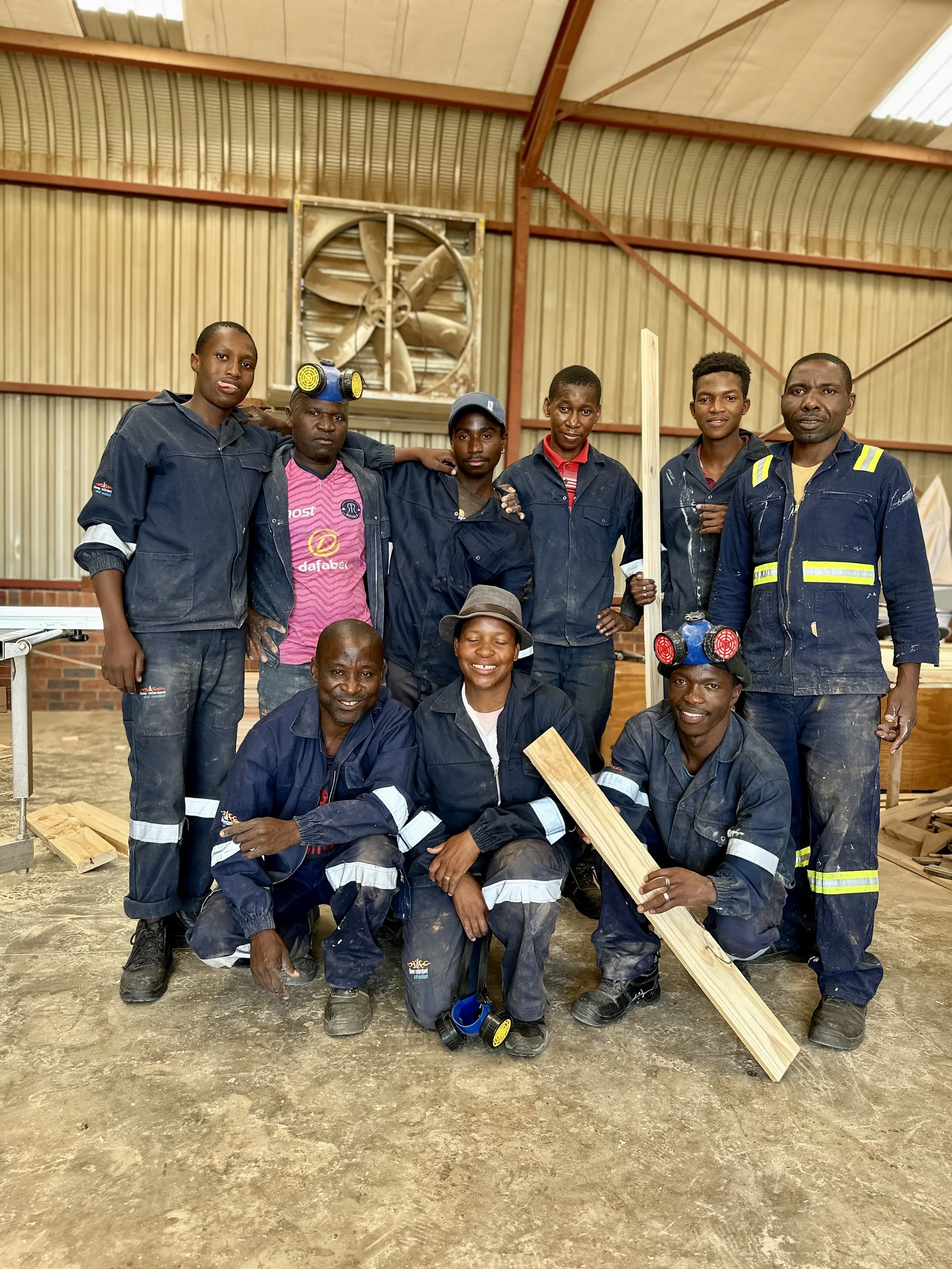 Photo of team and students in Overalls in the St Bonaventure Centre 