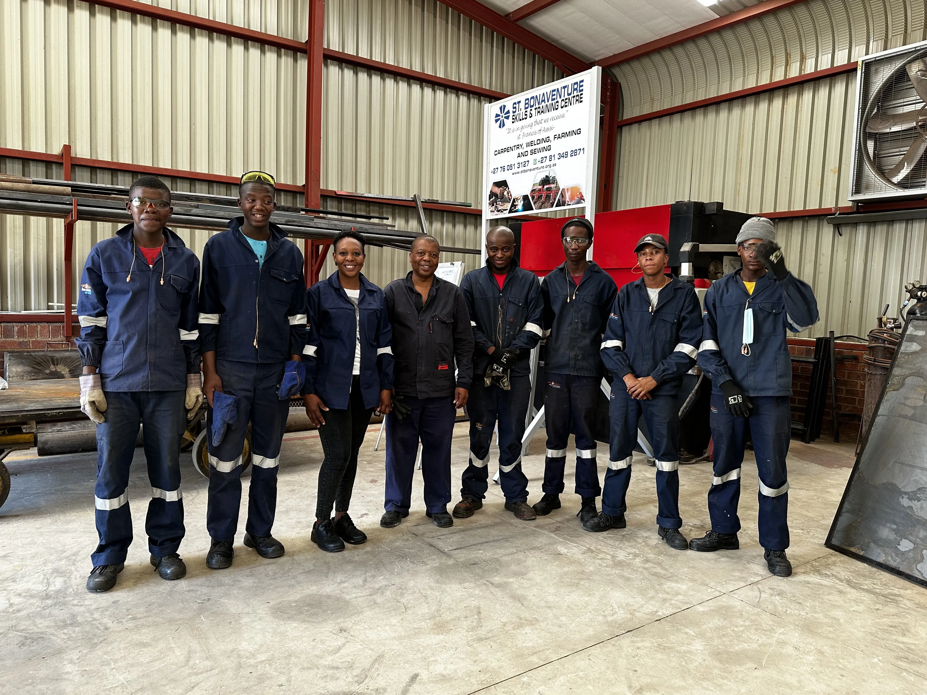 St Bonaventure team in the centre wearing overalls 