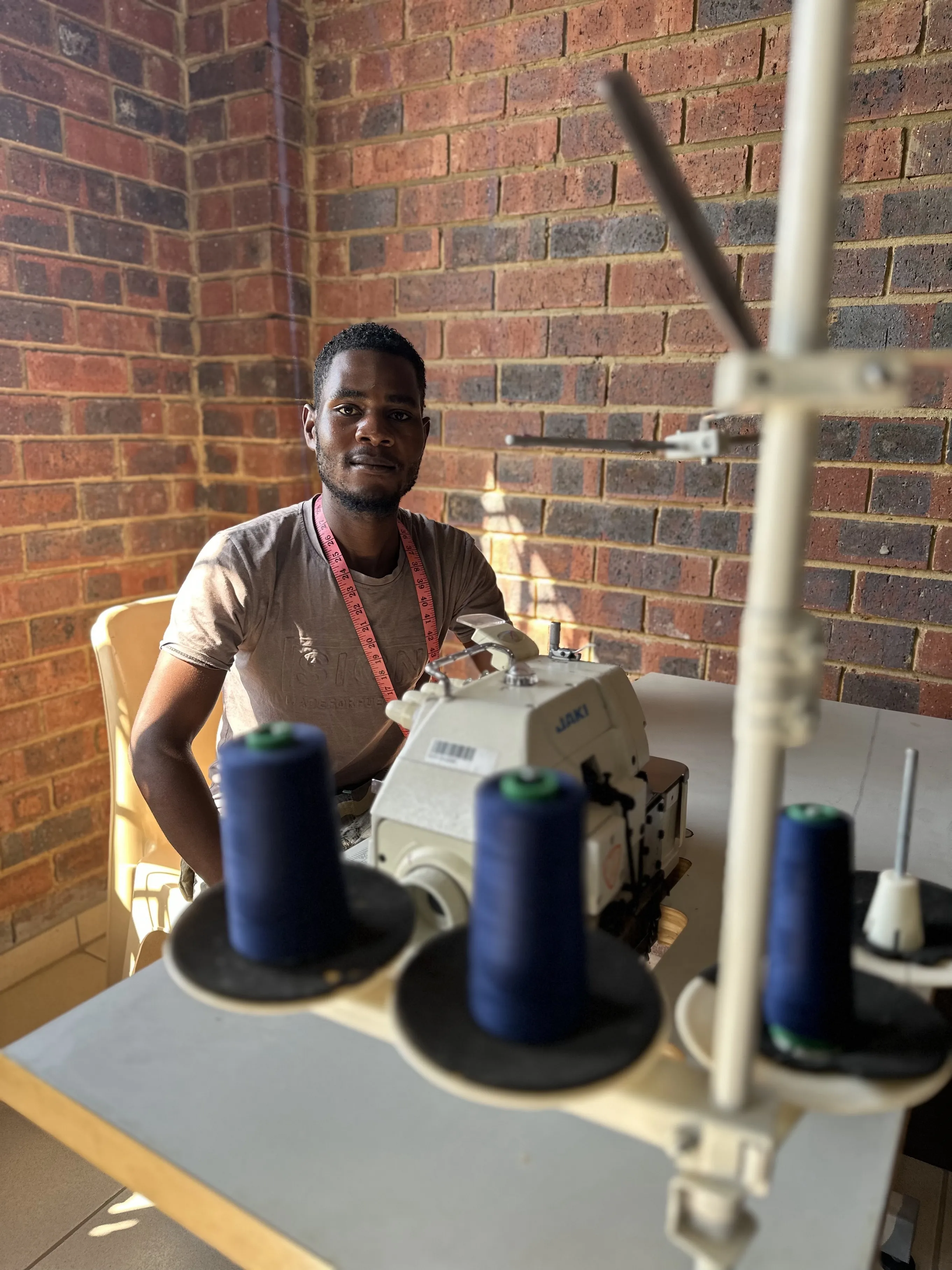 Our sewing facilitator at Sewing workspace with sewing machine 