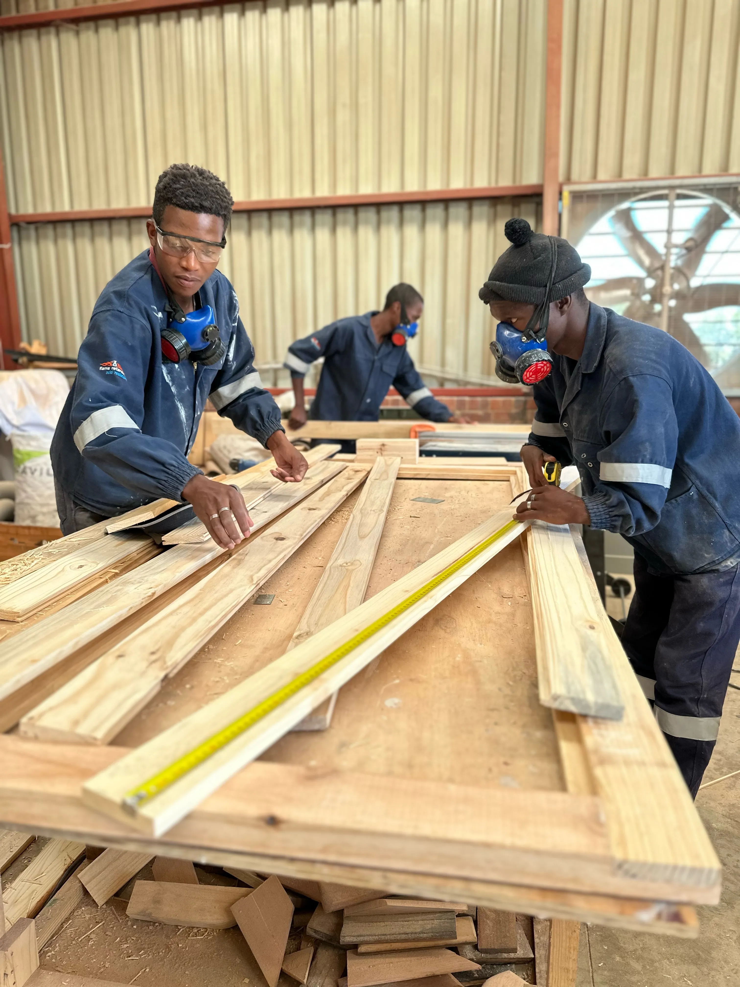 Photo of people at St Bonaventure Centre crafting furniture